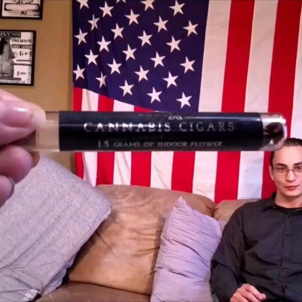 Holding up a pack of cannabis cigars in front of an American flag