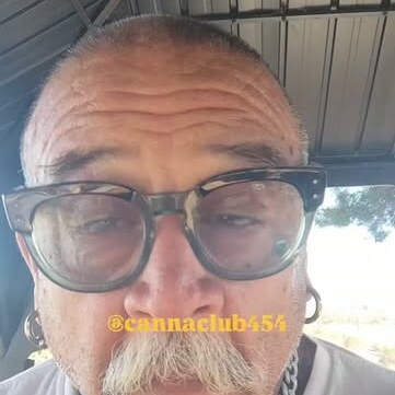 Club founder in glasses and a white tee talking to camera